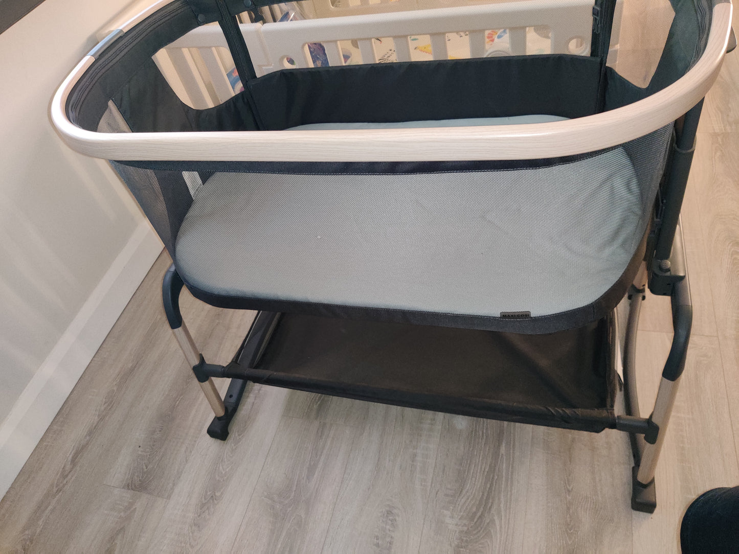 Maxi-cosi Iora Air beside crib.